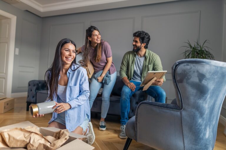 Three people in a room unpacking