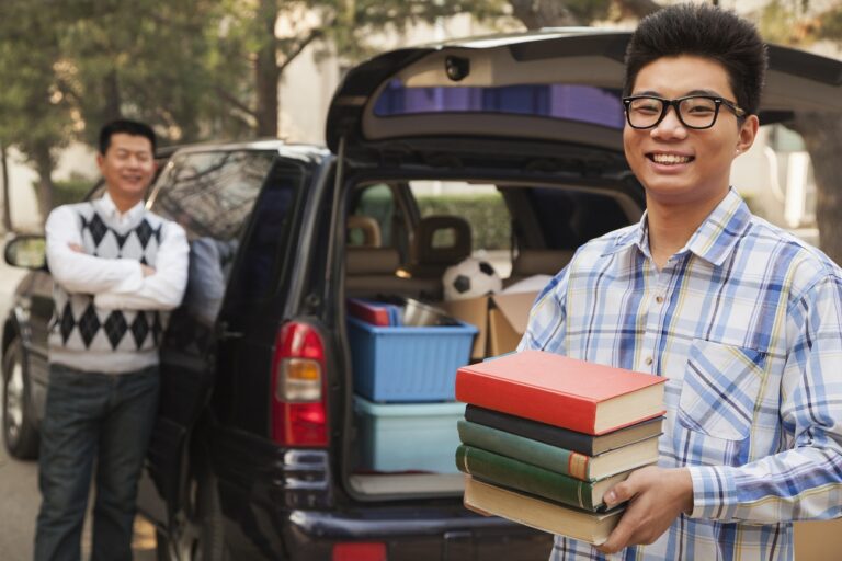 Boy unpacking car for college