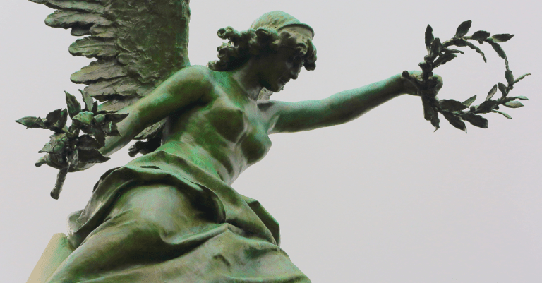 a statue holding a crown of laurels