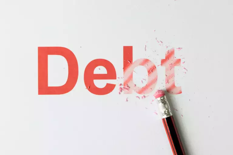 The word "debt" being erased by a pencil