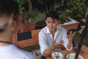 man at coffee shop giving rude look to waitress