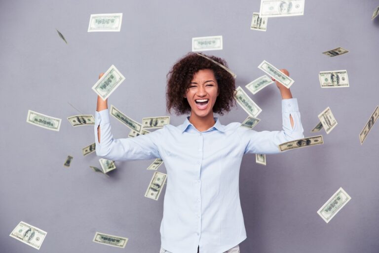 Woman with dollar bills falling on her.