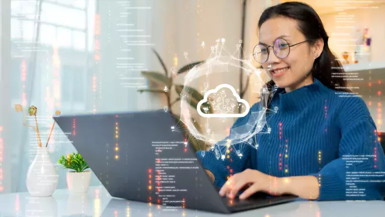 Woman at her laptop and a graphic of a cloud and computer data in front