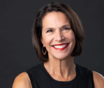 MonicaReinagel A woman wearing a black sleeveless top and smiling.